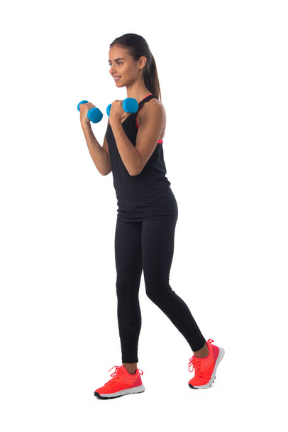 Healthy hispanic fitness girl with dumbbells working out isolated on white background - Φωτογραφία, εικόνα