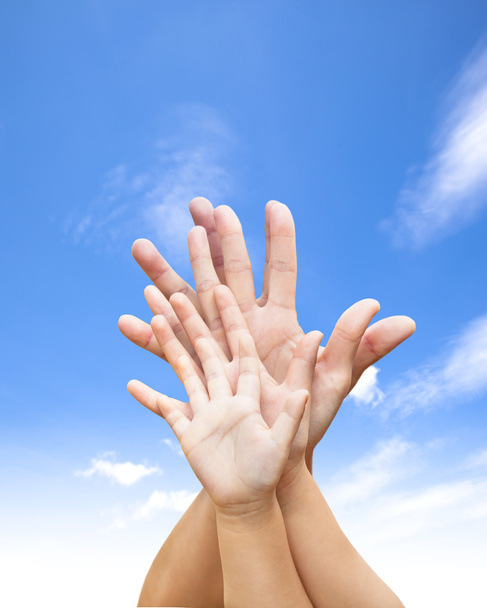 Семья объединила руки с голубым небом и облаком
 - Фото, изображение