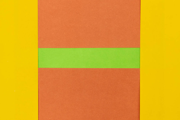 Green, Orange and Yellow coloured paper background, abstract contrast conceptual image - Photo, Image