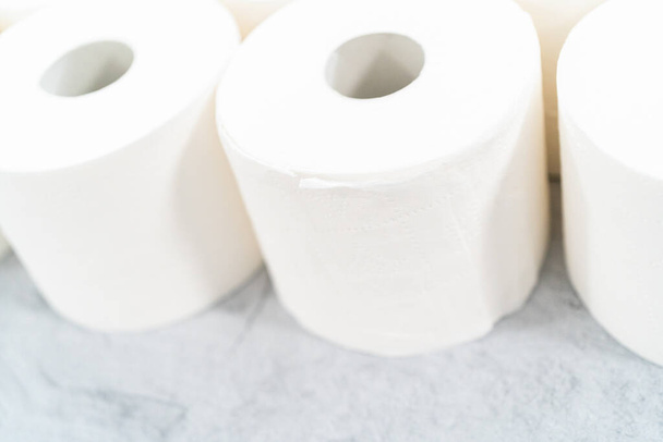 New white toilet paper rolls on a gray background. - Photo, Image