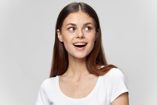 Camiseta larga de mujer con la boca abierta se ve a un lado  - Foto, Imagen