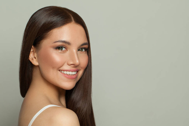 Pretty model woman with clear skin and long healthy straight hair. Skincare and facial treatment concept - Photo, Image