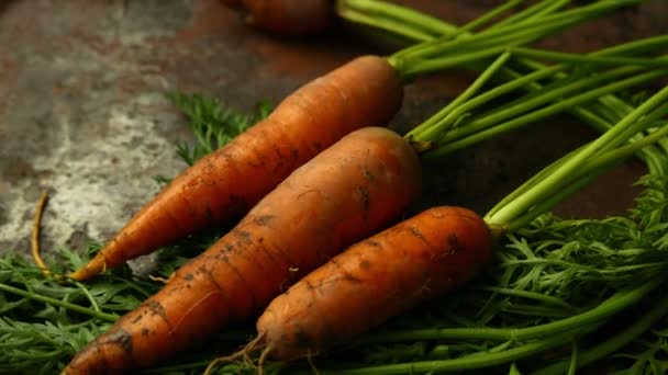 крупным планом сняты спелые морковки, лежащие на деревенском столе - Кадры, видео