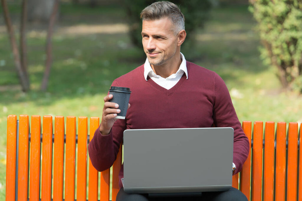 businessman work on laptop with coffee cup outdoor, agile business - Fotó, kép