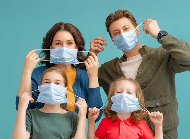 Family is wearing facemasks during coronavirus and flu outbreak. Virus and illness protection, quarantine. COVID-2019. Take on or take off masks.  - Φωτογραφία, εικόνα