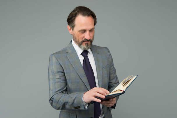 get ready for business training. successful man in business suit hold diary notebook. planning and success concept. reading a book. businessman find interesting information in book - 写真・画像