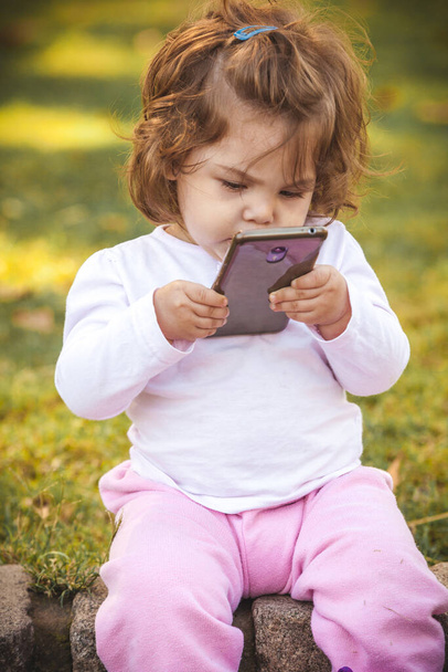 baby with mobile in park  - Foto, Imagen