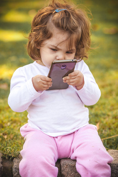 baby with mobile in park  - Photo, Image
