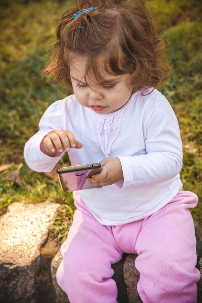 baby with mobile in park  - Foto, Imagen