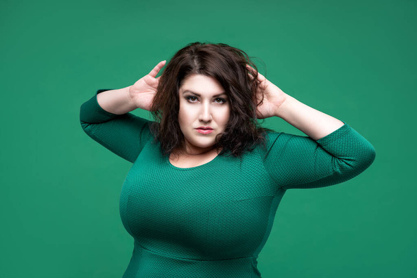 Plus size fashion model in green dress, fat woman on green studio background, body positive concept - Fotografie, Obrázek
