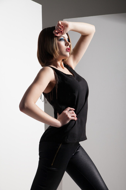 Fashion model wearing leather pants posing - Foto, Imagen