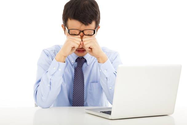 tired young businessman rubbing his eyes - Photo, Image
