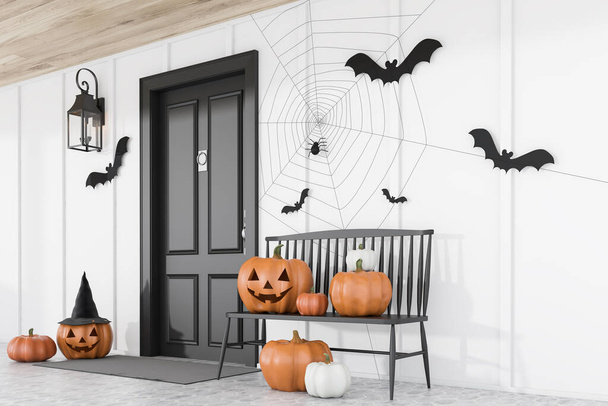 Carved pumpkins, bats and spiders near black front door of modern house with white walls and black bench. Side view. Concept of halloween. 3d rendering - Foto, Imagen