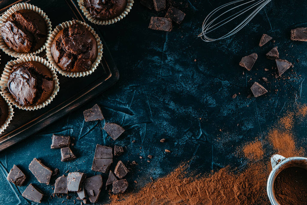 Lots of chocolate muffins on black background, free space for text - Фото, зображення