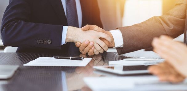 Handshake as successful negotiation ending, close-up. Unknown business people shaking hands after contract signing in modern office - Фото, зображення
