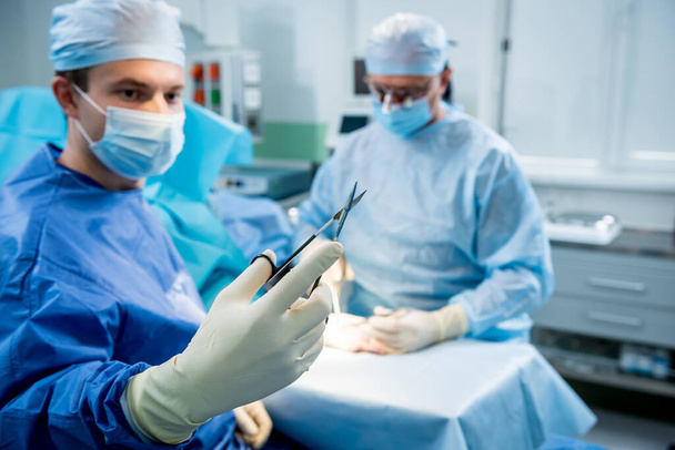 Surgeons in the operating room trying to save the patients hand. - Foto, imagen