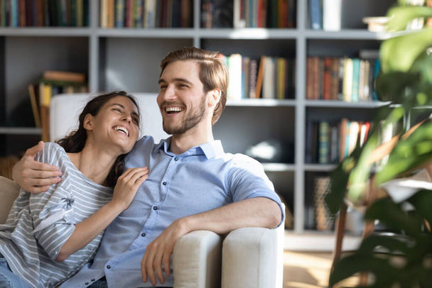 Overjoyed young couple having fun at home. - Foto, imagen