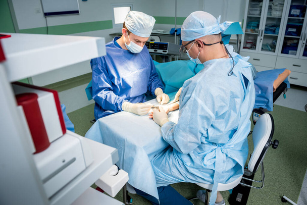 Surgeons in the operating room trying to save the patients hand. - Photo, Image