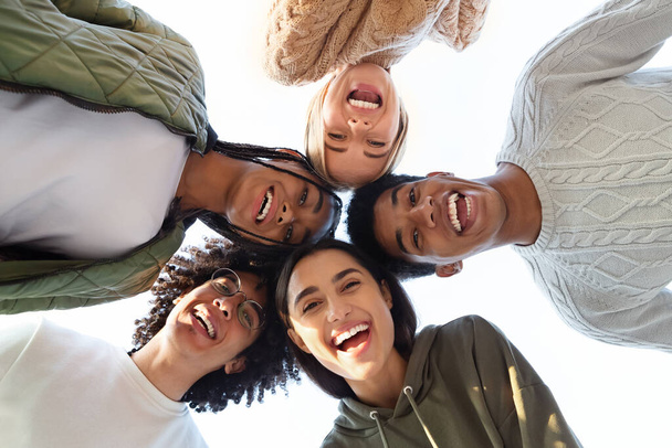 Smiling multiracial friends forming circle of heads - Φωτογραφία, εικόνα