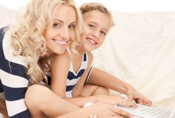 Happy mother and child with laptop computer - 写真・画像
