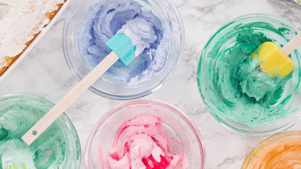 Mixing food coloring into Italian buttercream frosting. - Photo, Image
