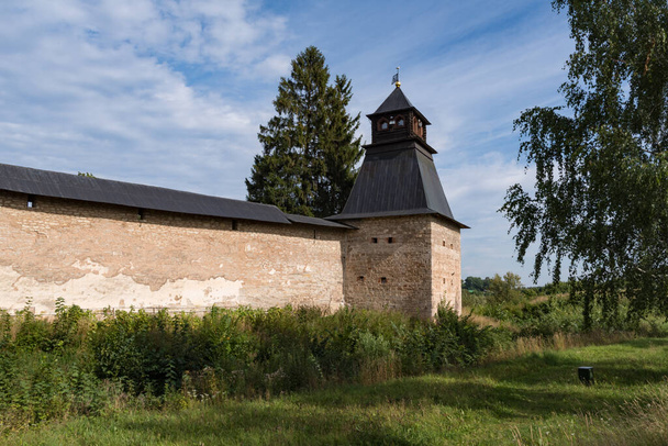 Annunciation Tower with fortress wall of Holy Dormition Pskovo-Pechersky Monastery. Pechory, Russia - Photo, Image