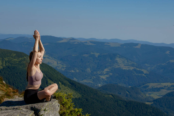 Yoga, Meditation. Woman balanced, practicing meditation and zen energy yoga in mountains. Girl doing fitness exercise sport outdoors in morning. Healthy lifestyle concept - Fotoğraf, Görsel