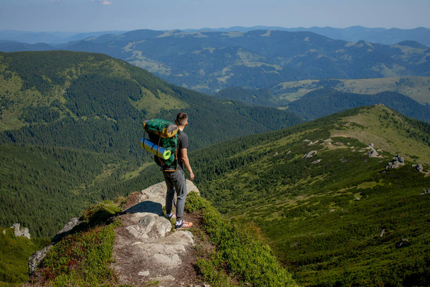 Hiker on the top in Carpathians mountains. Travel sport lifestyle concept. - Photo, image
