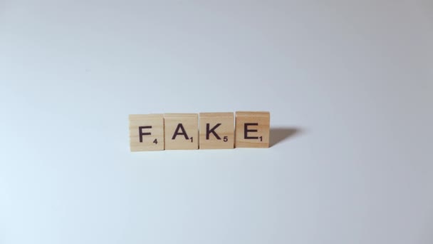 The letters from the word fake are eliminated to form the word fact,misleading information, myth busted - Footage, Video