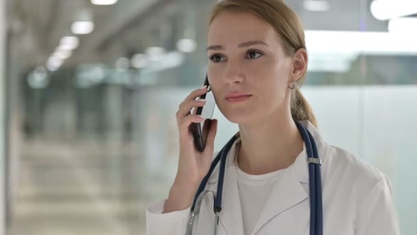 Portrait of Female Doctor doing Talking on Smartphone - Кадри, відео