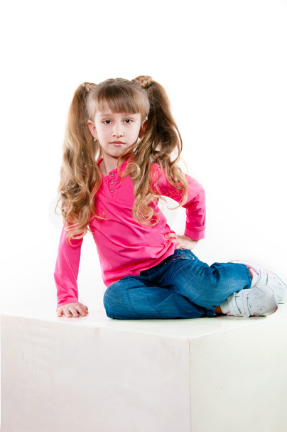 Little girl with long curly hair in a pink blouse - Фото, зображення