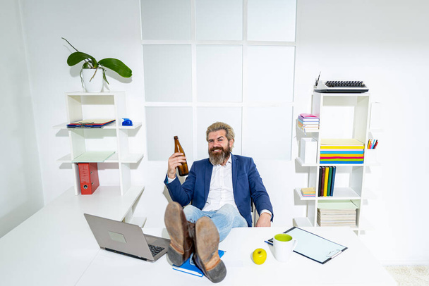 Sad businessman finished working day with alcohol. Alcohol addiction problem concept. A drunk business man in the office. - Fotoğraf, Görsel