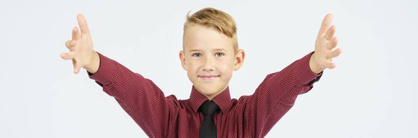 Portrait of a schoolboy with open arms who smiles. Education concept. - Foto, Bild