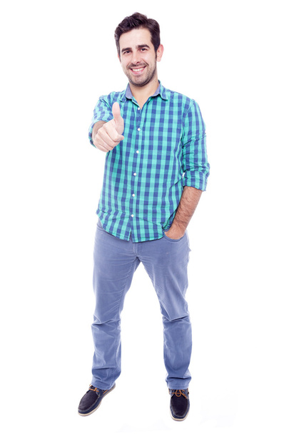 Handsome man thumbs up over a white background - Photo, Image