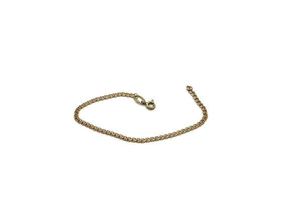 Gold bracelet for women on a white background - Foto, Imagen