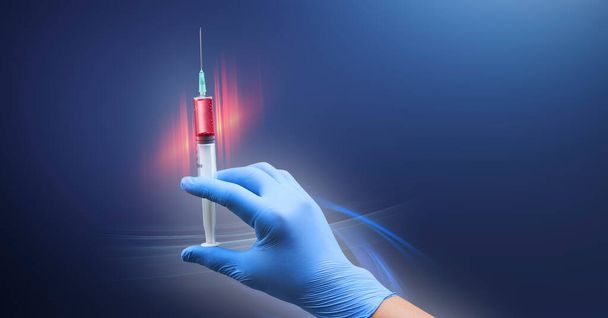 Doctor hand with medical drug needle syringe drug. Energy line highlighting the subject over deep blue background. Medical concept for health care, research, and science. - Photo, Image