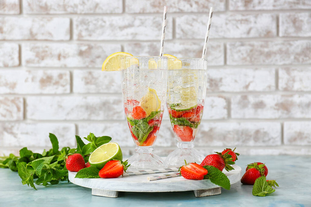 Glasses of tasty strawberry mojito on table - Zdjęcie, obraz