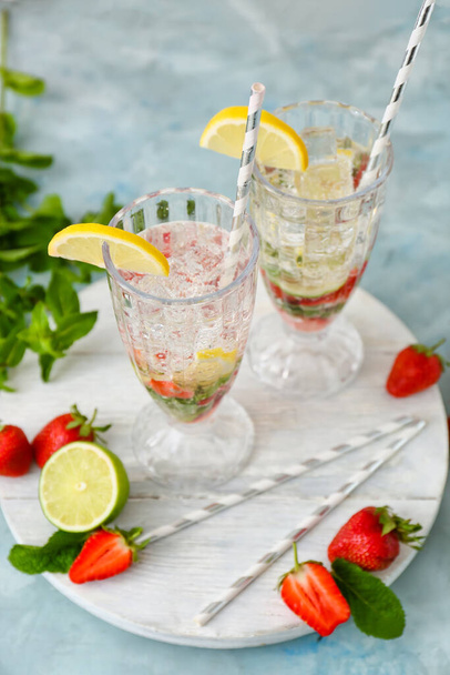 Glasses of tasty strawberry mojito on color background - Photo, Image