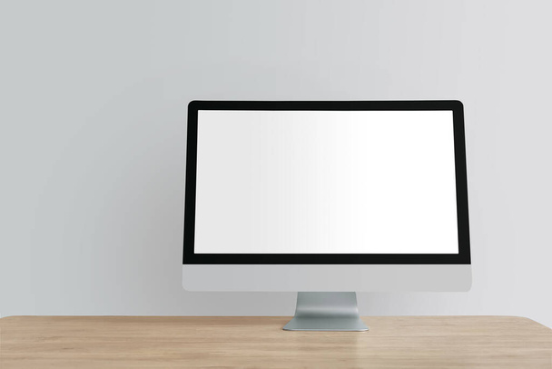 Modern PC monitor on table near light wall - Photo, Image