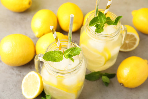 Natural freshly made lemonade and mint on light grey table. Summer refreshing drink - Photo, image