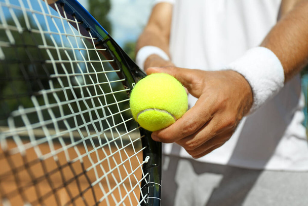 Sportsman preparing to serve tennis ball at court, closeup - Photo, Image