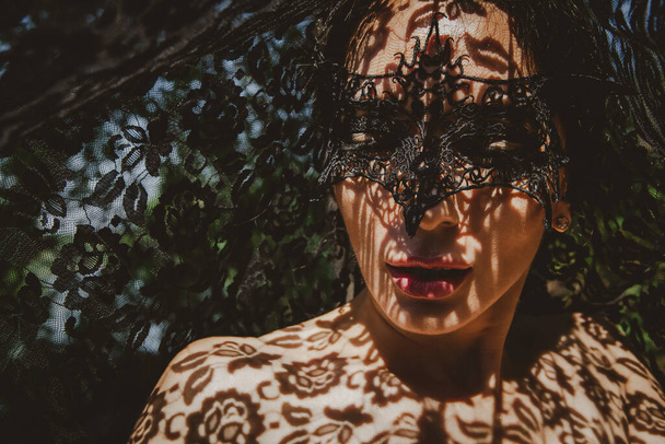 портрет жінки в мереживній масці з тінями на її обличчі
 - Фото, зображення
