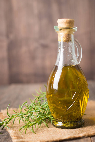 Rosemary oil on wooden background. Natural food concept.  - Foto, Bild