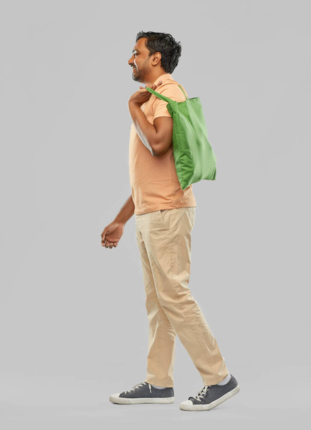 man with reusable canvas bag for food shopping - Foto, Imagem