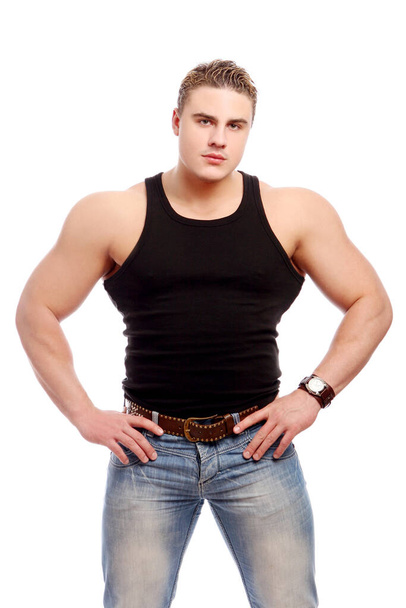 Young and attractive bodybuilder posing on white background - Фото, изображение