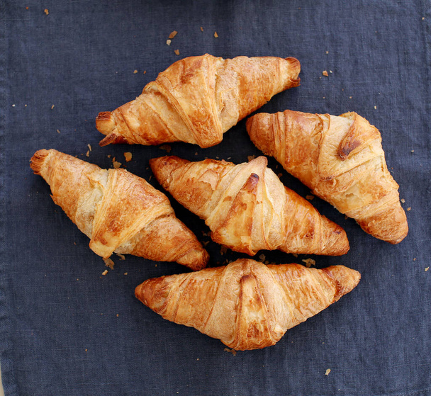 Bakery. Heap of delicious croissants on the tablecloth - Photo, Image