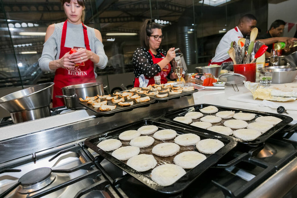 Johannesburg, South Africa - October 05, 2017: Diverse young people learning to cook and bake at a cooking class - Fotografie, Obrázek