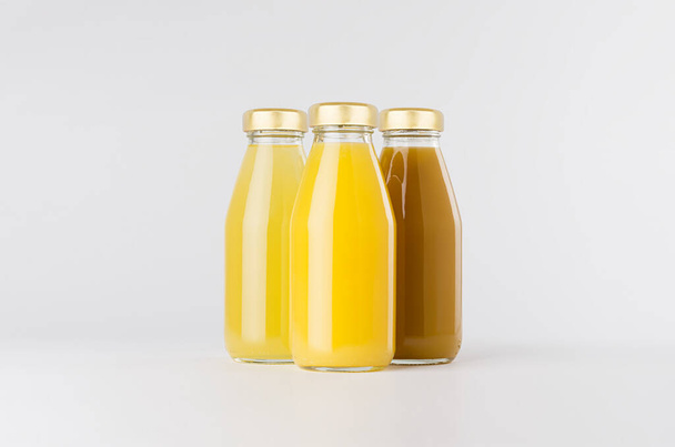 Modèle de collection de jus de fruits orange et jaune dans des bouteilles en verre avec groupe de bouchons sur fond blanc, modèle pour l'emballage, la publicité, le produit design, l'image de marque. - Photo, image