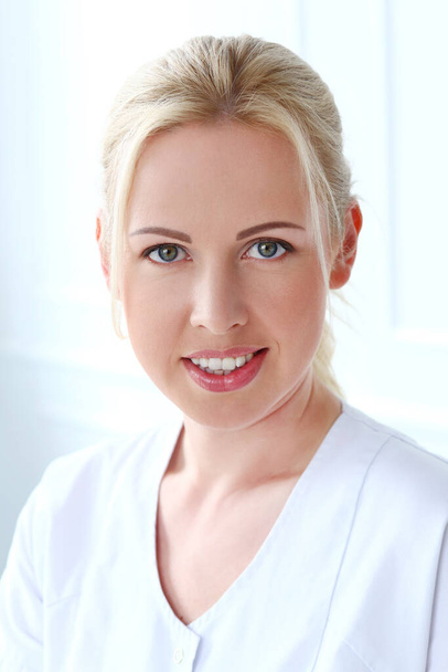 Professional. Beautiful cosmetologist on a white background - Photo, Image