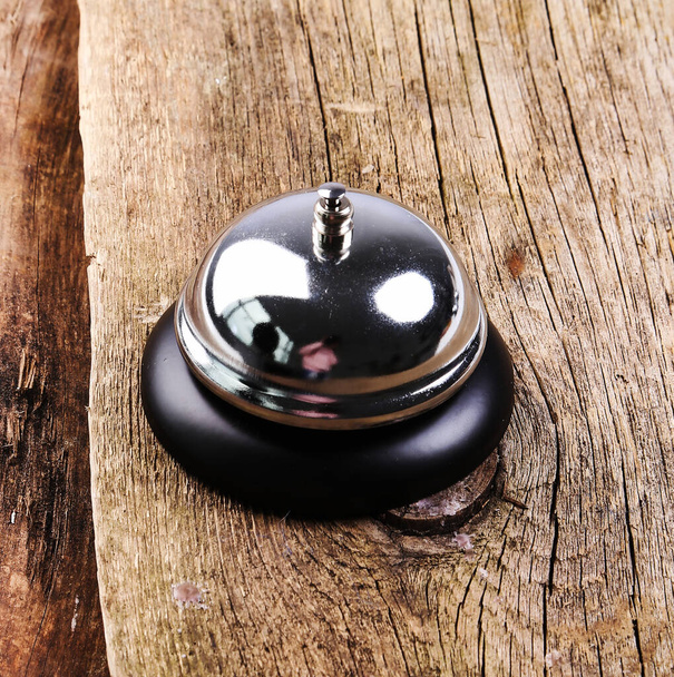 Ring bell on the wooden table - Foto, Imagen